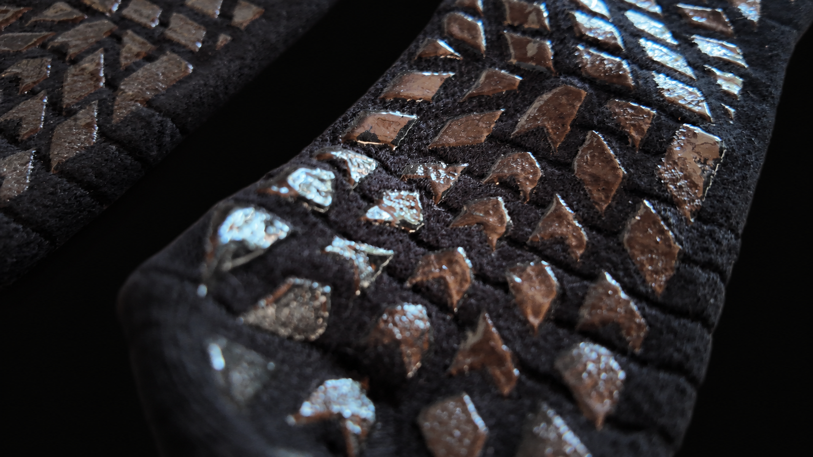Close-up of the actual geometric LOCK IN grip texture against black